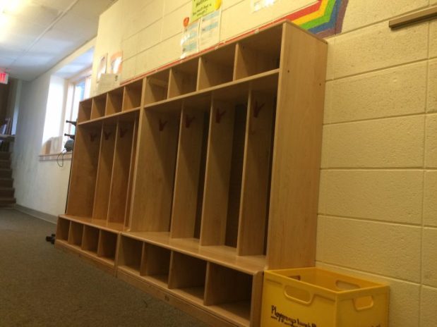 Children store their coats and backpacks in the cubbies outside the classroom.